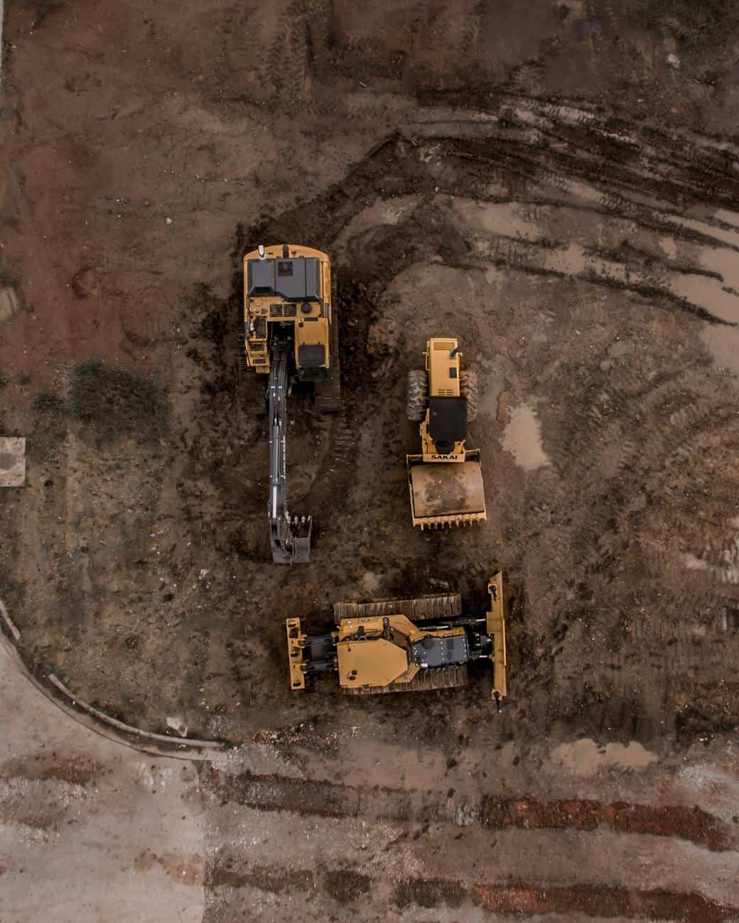 Aerial view of Rossini Equipment Corp excavators and track loader on a job site